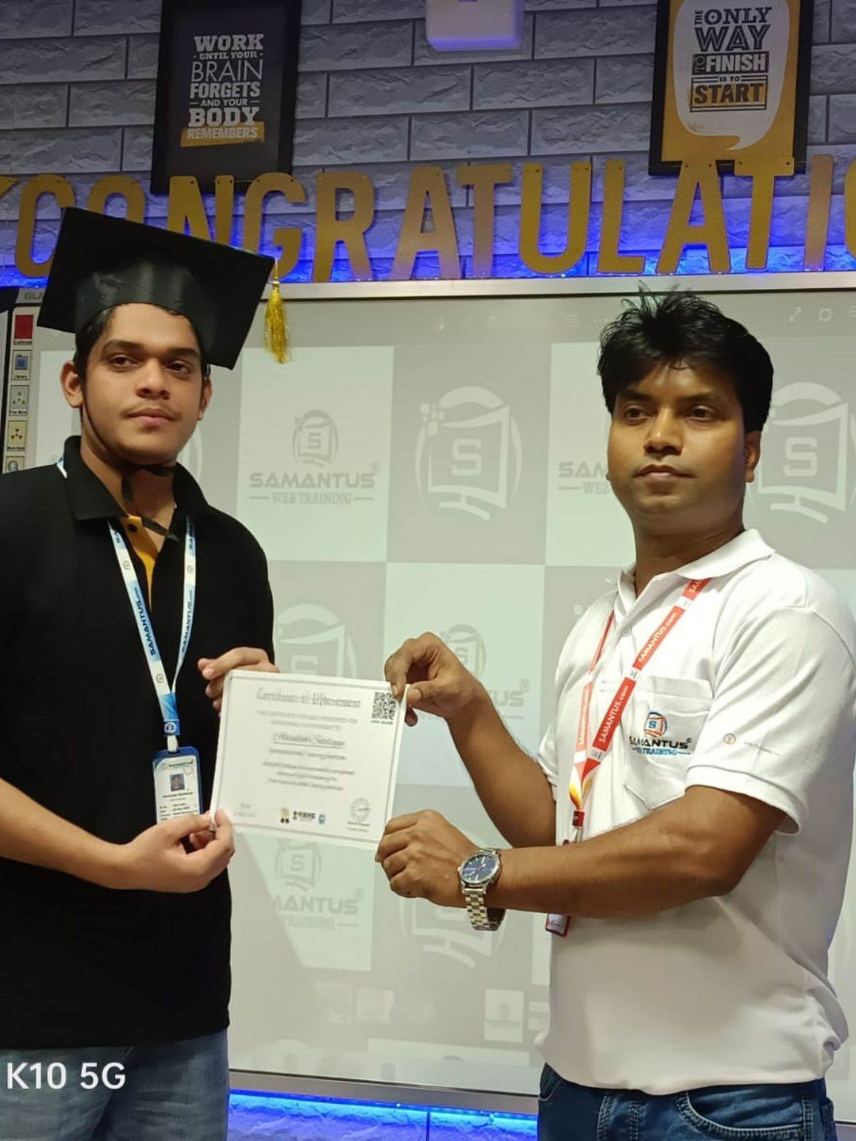 Student holding certificate