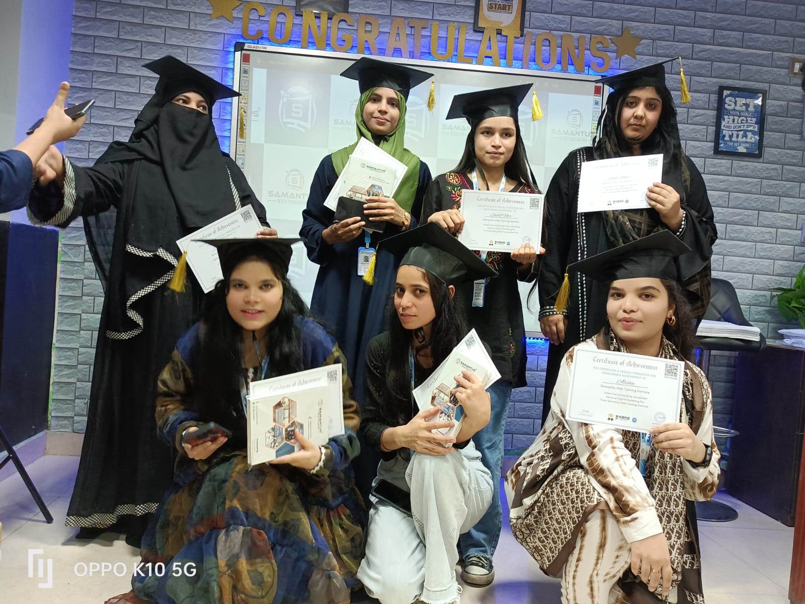 a group of women holding certificates